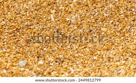 Small orange crushed stone. As a background. Royalty-Free Stock Photo #2449812799