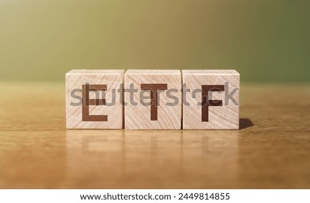 A wooden block spelling out the acronym ETF in a close-up shot.