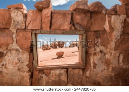 Fine art photography of the hot desert landscape of Arizona as seen framed from an old, abandoned house window. 