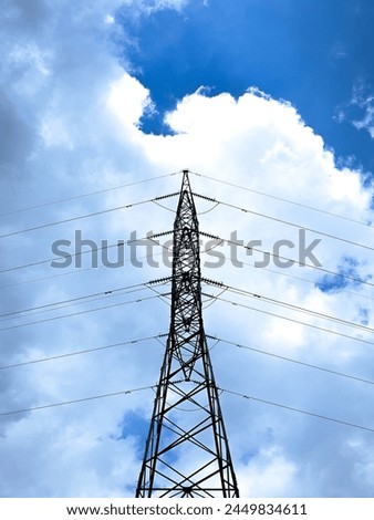 Bandar Lampung, Indonesia - February 5, 2021 : The symmetrical shape of an electricity pole with a sky background taken from a low angle in the city of Bandar Lampung, Indonesia Royalty-Free Stock Photo #2449834611