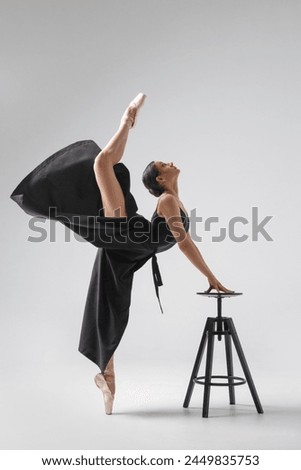 Elegant girl ballerina in pointe shoes isolated on white background.