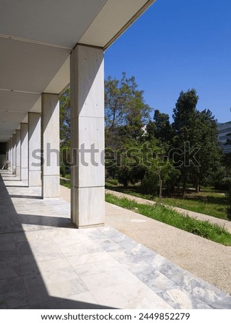 Corridor colonnade in a row diminishing perspective in a sunny day  Royalty-Free Stock Photo #2449852279