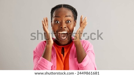 Excited, black woman and surprise with good news for winning, celebration or prize on a gray studio background. Portrait of African female person with smile for lucky draw or lottery on mockup space