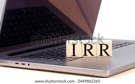 IRR word on a wooden block on laptop , business concept. 