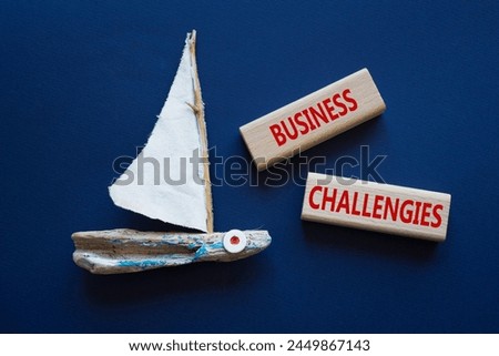 Business challenges symbol. Concept word Business challenges on wooden blocks. Beautiful deep blue background with boat. Business and Business challenges concept. Copy space