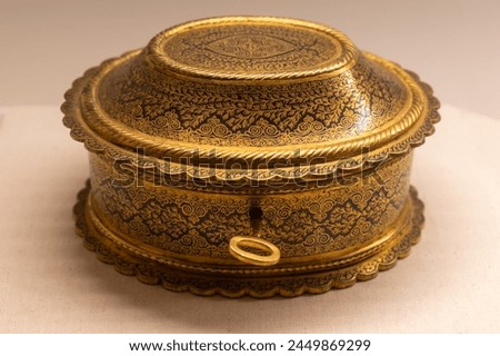 Gold Jewel box with carving hand made. Small old antique handmade container made of metal with lid. old vintage antique golden casket case chest jewelry engraving. Royalty-Free Stock Photo #2449869299