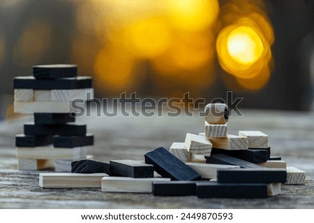 Peaceful rest in nature in sunny weather. The game "Jenga", "Wooden tower" against the background of nature. Concentration, calmness, choice, decision-making. High quality photo