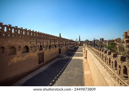 Pictures of the Ahmed Ibn Tulun Mosque in Cairo, showing minarets and a blue sky