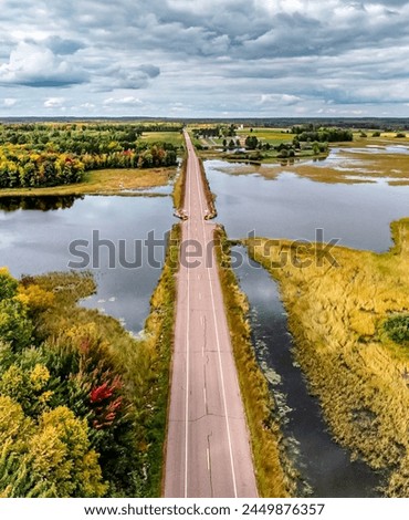 Aerial View of Scenic Road, Lakes, Green Fields, Cloudy Sky - High-Quality Landscape Photography for Travel, Adventure, Exploration - Perfect Nature Backdrop for Peaceful and Idyllic Environmental Bea