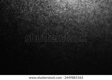 Grainy abstract texture on a black background. Snow texture. Design element.
