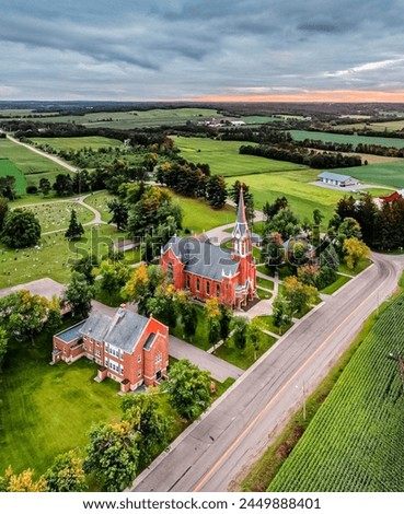Aerial View of Red Church at Sunset, Scenic Rural Landscape, Agriculture Fields, Serene Nature Background, Vibrant Colors, Travel Destination, Historical Landmark, Outdoor Photography, Peaceful Enviro