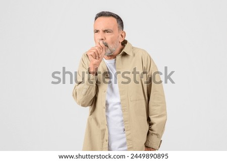 Sick senior man smoker coughing isolated on white background, grandfather suffering from cold or flu Royalty-Free Stock Photo #2449890895