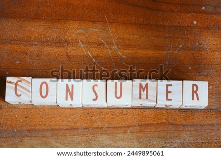 A collection of words arranged in wooden blocks "CONSUMER"