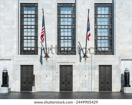 White marble entrance to the Supreme Court of Ohio in Columbus with US flag flying