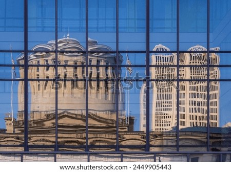 Reflection of the Ohio state Capitol building in the windows of an office building across the street in Columbus, OH