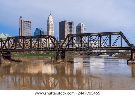 Columbus Ohio waterfront view of the downtown financial district from the River Scioto through a railroad truss bridge