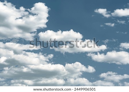 Fluffy cumulus clouds on a bright blue sky, tinted, natural atmosphere backgrounds