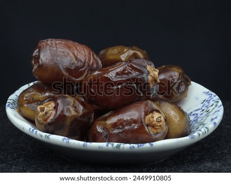 A Small Serving of Dates Arranged Elegantly on a Plate