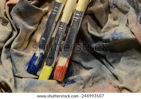 Painting a picture of saturated colors with acrylic paints using brushes of different sizes