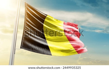 Belgium national flag waving in beautiful sky.