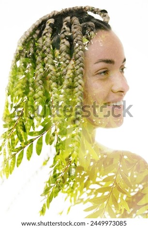 A double exposure portrait of a woman merged with a photo of green tree leaves.