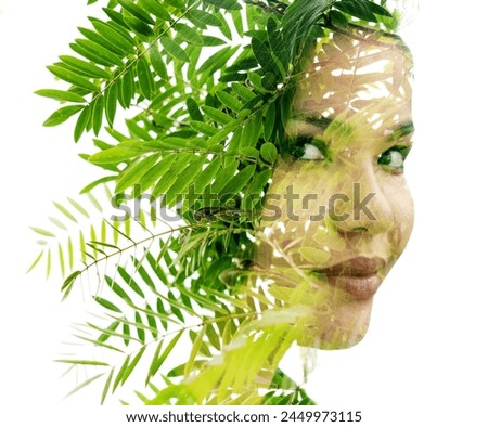A double exposure woman's portrait merged with a photo of green leaves