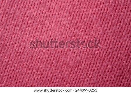 A detailed close-up perspective of a vibrant pink fabric, showcasing its texture, weave, and color variations in a high-definition capture.