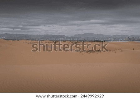 Desert scene in Wuhai . Inner Mongolia. China. Tall dunes with copy space for text. Dramatic sky