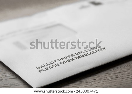 Ballot paper postal vote letter for the Local Elections in England. On a wood table top Royalty-Free Stock Photo #2450007471