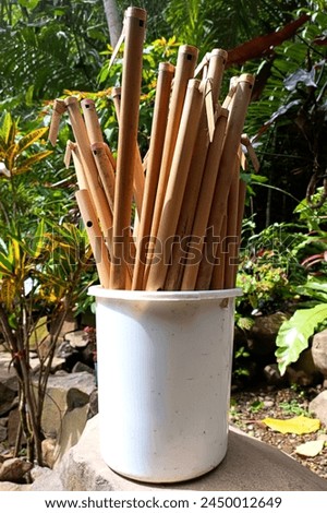 a bucket of flute made of bamboo which is being dried in the sun, this bamboo flute is a typical flute from the province of West Java, Indonesia.