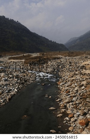 terai-dooars region of west bengal at dudhia. beautiful mountain stream (balason river) flowing through the valley, himalaya foothills area in india Royalty-Free Stock Photo #2450016815