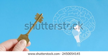Key in hand and picture of brain conceptual photo