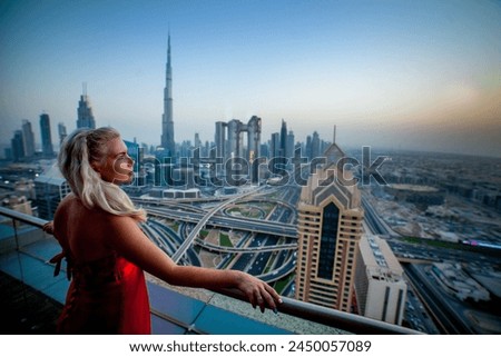UAE Dubai skyline at sunset with Burj Khalifa, the world tallest building and Sheikh Zayed road traffic