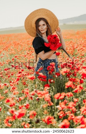 Woman poppies field. portrait happy woman with long hair in a poppy field and enjoying the beauty of nature in a warm summer day.