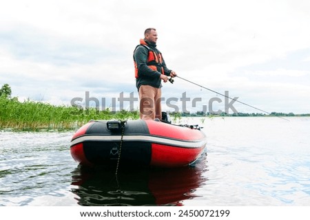A man during morning fishing from an inflatable boat. Men's hobby, outdoor recreation