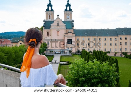 Woman in summer romantic dress at chapel castle travel destination. Summer castle and woman. Banner.