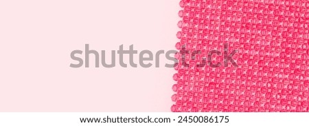 Banner with detail for handcraft bag made from square beads on a pink background. 