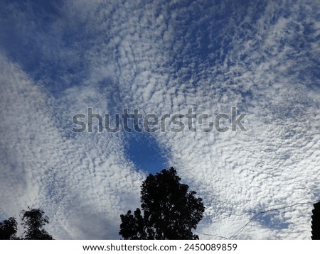 white clouds like snow in the sky Royalty-Free Stock Photo #2450089859