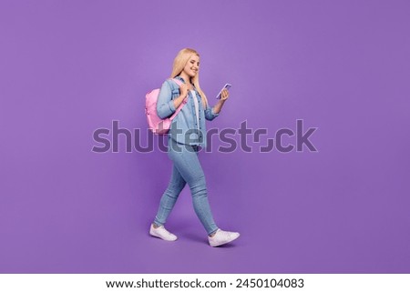 Full length body size view of attractive cheerful girl going using device app 5g isolated over vivid violet purple color background