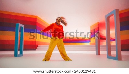 Colorful Geometric Abstract Aesthetic: Portrait of Black Woman Happily Dancing to Energetic Music in a Studio. Lively Female Dancer Celebrating Life and Youth, Expressing Herself Through Movement