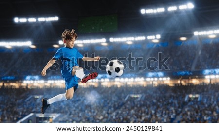 Aesthetic Shot Of Athletic Child Soccer Football Player Jumping And Kicking Ball Mid-Air On Stadium WIth Crowd Cheering. Young Boy Scoring a Winning Goal on Junior World Championship Tournament Match. Royalty-Free Stock Photo #2450129841