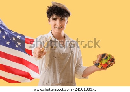Male artist with USA flag and paint palette on yellow background