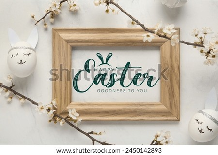 Beautiful Easter greeting card with frame, blooming branches and eggs on light background