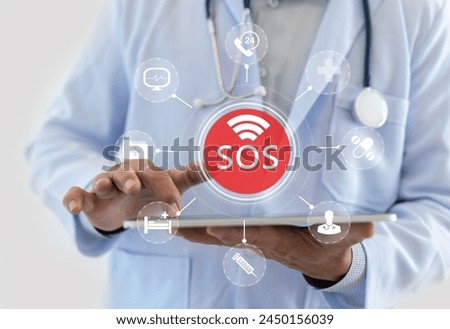 Innovative healthcare medical doctor holding SOS alert hologram healthcare icons, emergency services advanced medical assistance, modern telemedicine, urgent care, healthcare services, medical apps Royalty-Free Stock Photo #2450156039