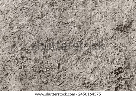 Ancient gray adobe wall, close up background photo texture