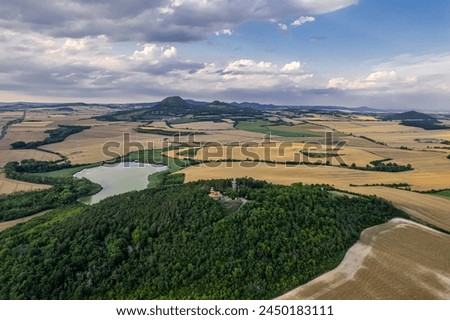 Aerial view of wavy hills with agricultural fields in spring. Central Bohemia region, Czech Republic, Europe