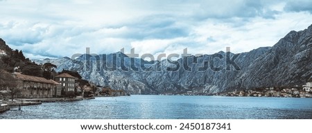 Panoramic landscape with old church in Kotor, Montenegro.Harbor and boats on a sunny day in Boka Kotorska bay, Montenegro, Europe	 Royalty-Free Stock Photo #2450187341