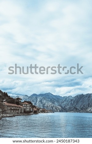 Panoramic landscape with old church in Kotor, Montenegro.Harbor and boats on a sunny day in Boka Kotorska bay, Montenegro, Europe	 Royalty-Free Stock Photo #2450187343