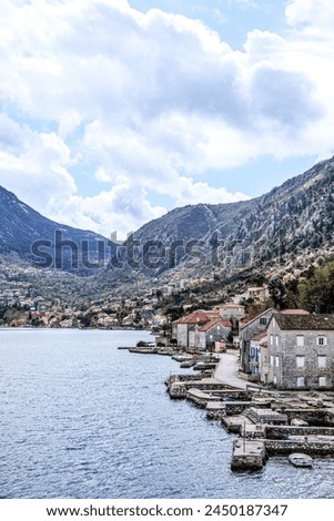 Panoramic landscape with old church in Kotor, Montenegro.Harbor and boats on a sunny day in Boka Kotorska bay, Montenegro, Europe	 Royalty-Free Stock Photo #2450187347