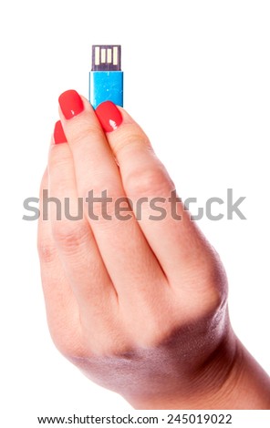 Beautiful woman hand with manicure holding usb flash